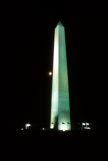 Washington Monument at night with a full moon